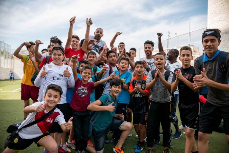 A group of young people cheering together at a community event