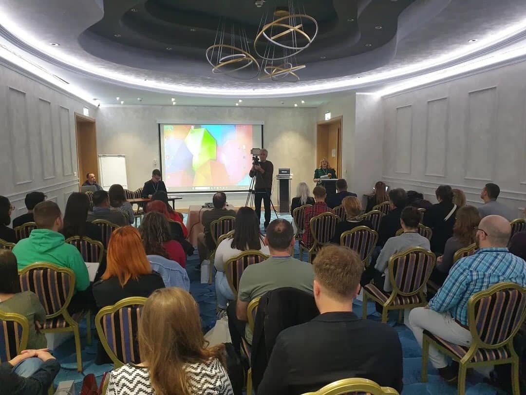 A presenter speaking to a room of young people at a bootcamp